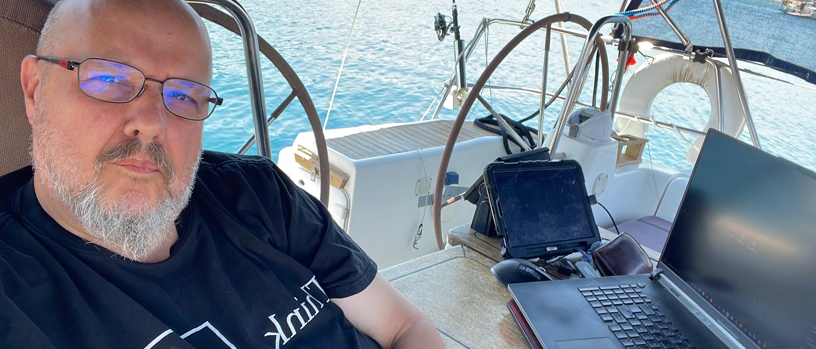 Bart Schillebeeks working aboard, laptop at the cockpit table
